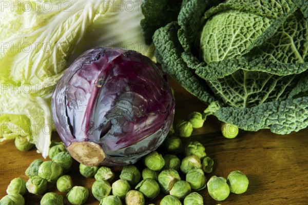 Still life with assortment cabbages on wooden table
