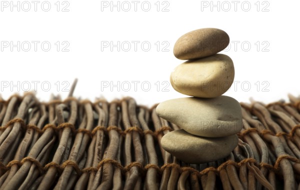 Stacked stones on wooden base. White isolated
