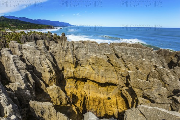 Pancakes Rock is a natural wonder of New Zealand. Paparoa Park. Stone flat pancakes, stacked on top of each other. The concept of ecological, active and photo tourism