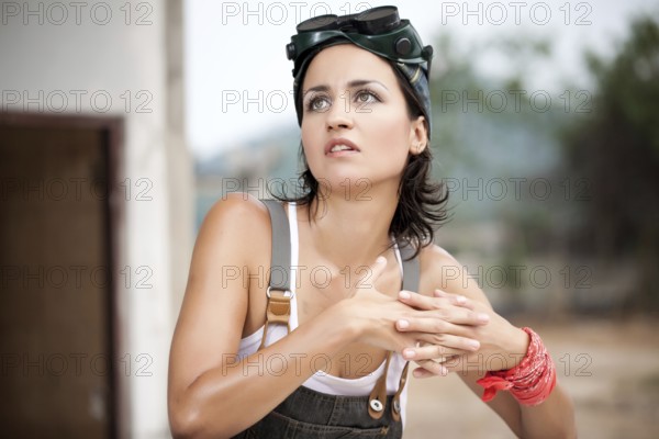 Pretty woman in denim coveralls. Close Up Portrait