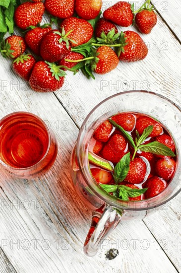 Glass decanter with delicious strawberry compote of fresh berries