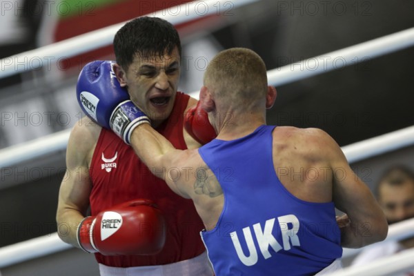 Sofia, Bulgaria. 27th February, 2021. Bobo-Usmon Baturov (red) of Uzbekistan and Yevhenii Barabanov of Ukraine fight in their final round of Welter (69kg) category of the 72-nd International Boxing Tournament Strandja 2021, Sofia, Bulgaria, Europe