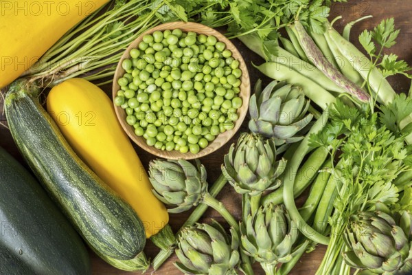 Fresh organic green vegetables wooden floor with copy space. Green and yellow vegetables background. Healthy eating background. Vegetarian food, organic food
