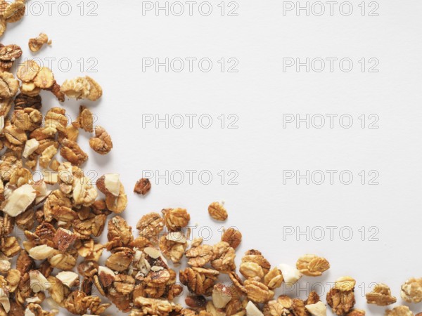 Homemade granola isolated one edge on white background. Ingredient for healthy breakfast. Copy space for text