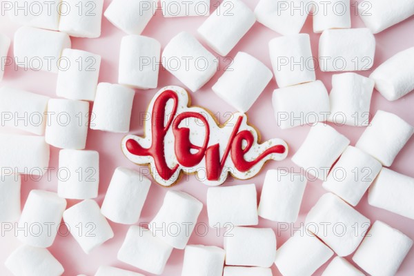 Gingerbread cookies love with white marshmallow. Valentine card. Pink background.