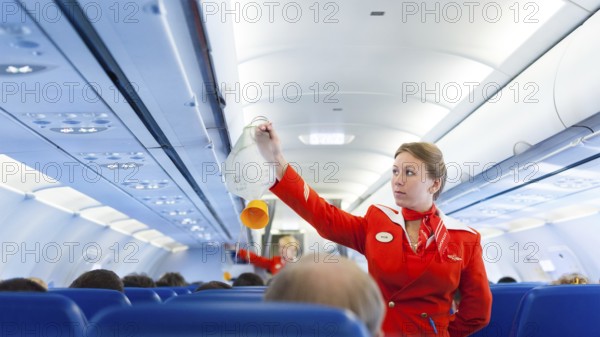 MOSCOW - MAY 28, 2011: Air hostess Yulia of Aeroflot shows how to use an oxygen mask on board. Aeroflot operates the youngest fleet in the world among major airlines, numbering 150 airliners