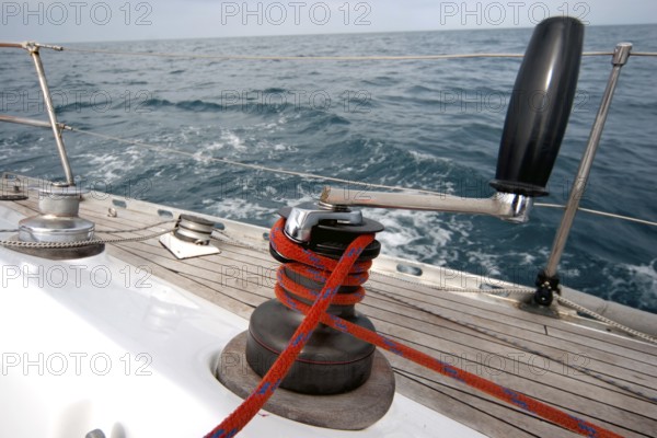 Winch with rope on sailing boat in the sea