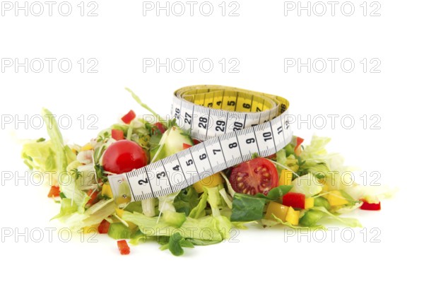 Fresh healthy mixed salad with measuring tape