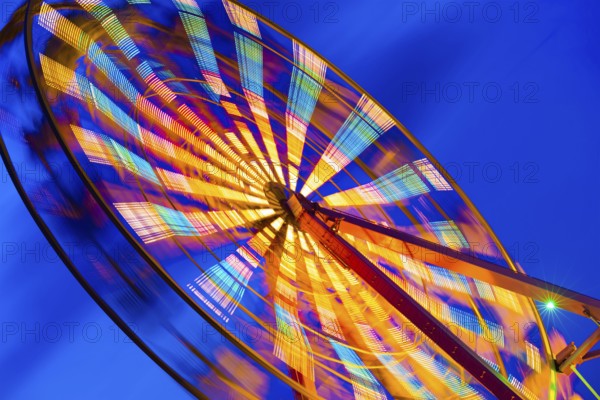 Turning illuminated ferris wheel shot at long exposure