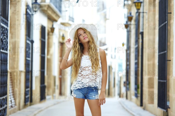 Blond tourist girl in mediterranean old town of Spain