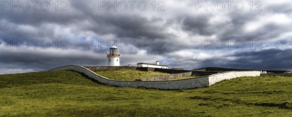 A view of the historic harbor lighthouse at St. John's Point in Donegal Bay in the north of Ireland