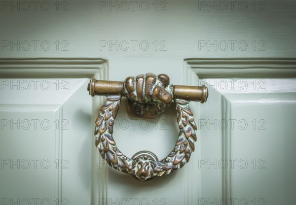 Ornate Brass Door Knocker On A Mint Green Door In Middle England