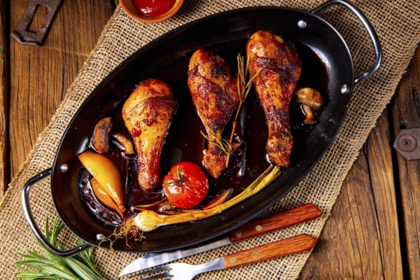 Grilled chicken legs in a barbecue marinade with sweet potatoes