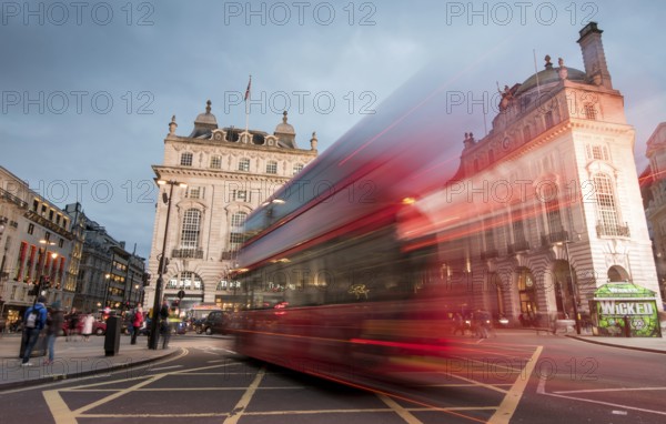 London, England, March 19, 2018: Night scene from the famous London Piccadilly circus square at the centre of London with cars and buses leaving colorful light traces