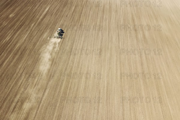 Aerial Tractor sowing crops at field