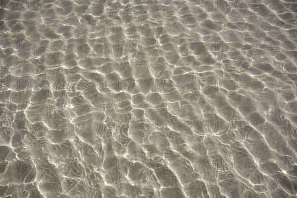 Caribbean transparent water beach reflections in shallow white sand bottom