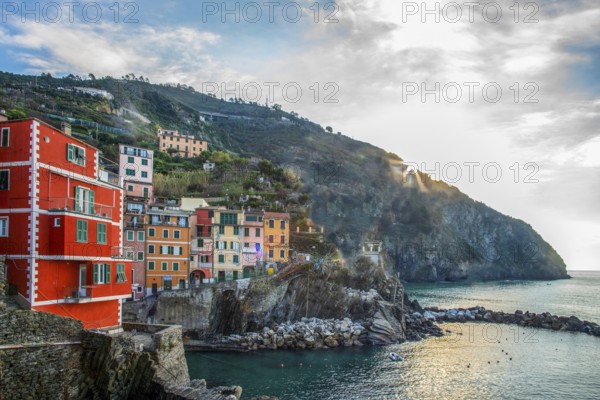 Riomaggiore first colorful place near La Spezia on Liguria coast in Italy, fanatstic small colorful building on rocky hill, travel on Christmas holidays in warm Italy (south of Europe)