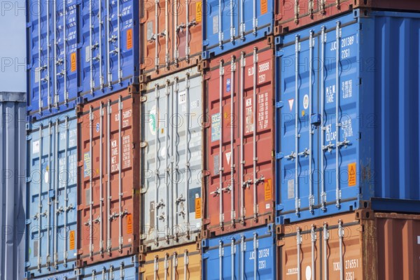 Stacked colourful freight containers at the container terminal in Holz-und Fabrikenhafen, Bremen, Germany, Europe