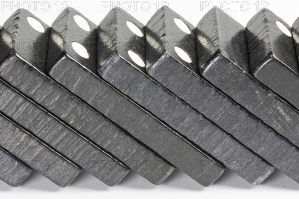 Composition of lying black domino bricks with white dots