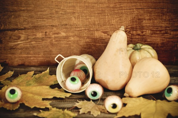 Halloween sweets, autumn leaves and pumpkins for Halloween party