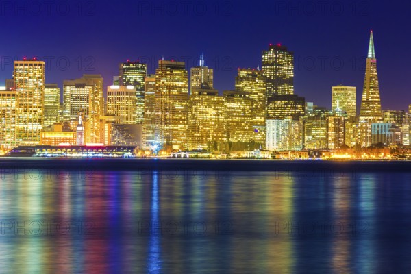 San Francisco sunset skyline in California with reflection in bay water USA