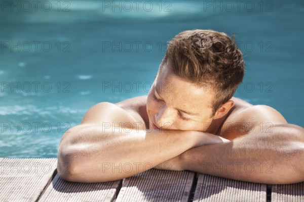 An image of a handsome man in the pool