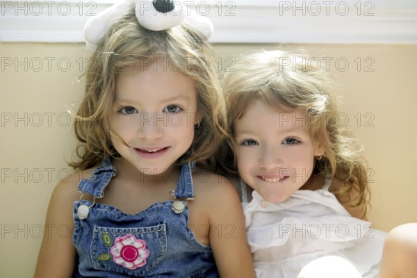 Two little beautiful toddler twin sisters portrait