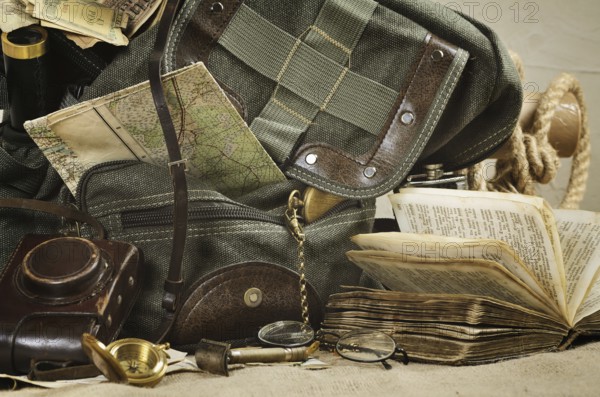 Still life with an old backpack and travel accessories