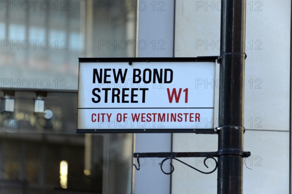White street sign with black and red lettering, urban environment, London, London region, England, United Kingdom, Europe