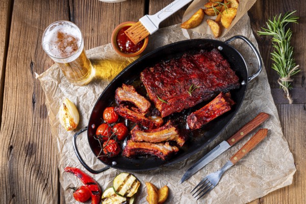 Grilled ribs in a spicy marinade with salad and vegetables