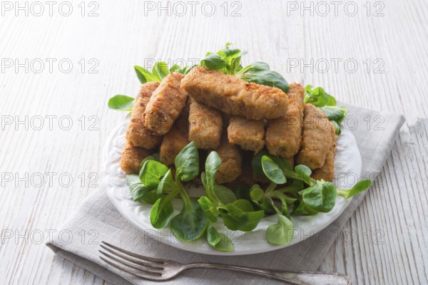 Home-baked fish sticks with salad