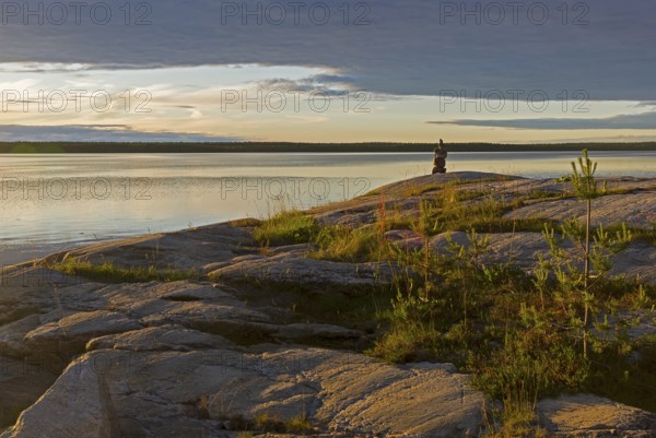 Evening on the White Sea. Stone pillar on coastal granite rock. Kandalaksha Gulf, Karelia, Russia, end of June, Europe