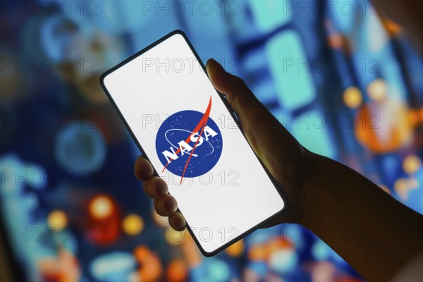 In this photo illustration, the NASA (National Aeronautics and Space Administration) logo is displayed on a smartphone screen