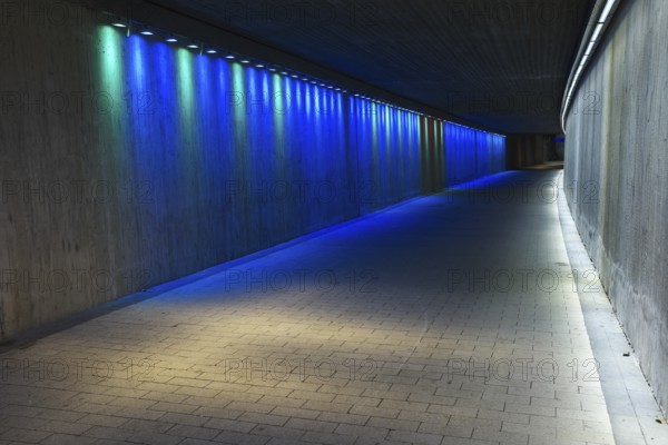Empty underground concrete tunnel with colorful lighting