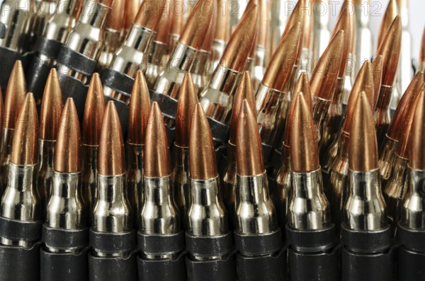 Chain of bullets over white, closeup, horizontal