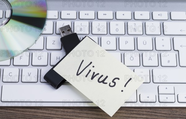 The photo shows a keyboard, CD and USB memory stick with sticker