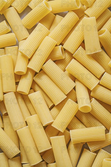 Short-cut uncooked pasta backdrop food and drink concept