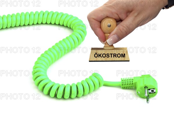 Symbolic image, stamp with the inscription: electricity costs, a green power cable, studio