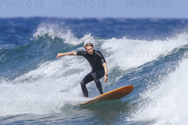 BELLS BEACH, AUSTRALIA, JANUARY 26 2024: Surfers in action at the iconic Bells Beach on a warm summer's afternoon near Torquay, Victoria, Australia, Oceania