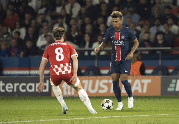 Football match, Desire DOUE Paris St. Germain right on the ball in a duel with Viktor TSYGANKOV Girona FC looking from behind with shirt number 8, Parc des Princes football stadium, Paris