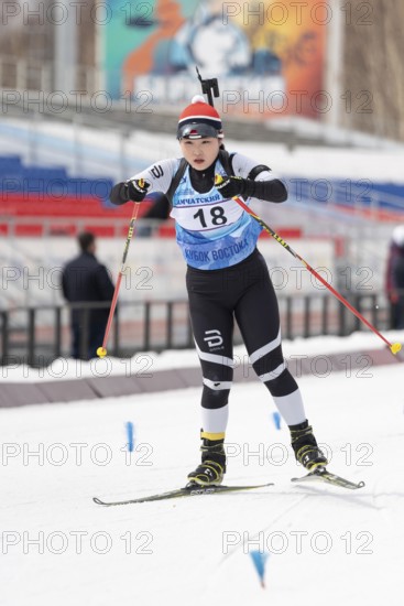 Korean sportswoman biathlete Choi Yoonah skiing on distance biathlon stadium during Open regional youth biathlon competitions East Cup. Kamchatka Peninsula, Russian Far East, April 12, 2019