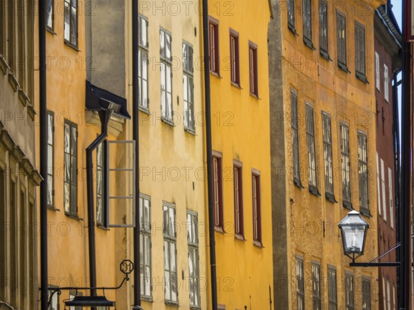 Narrow street with historic colourful facades, typical architecture of a Scandinavian city, stockholm, baltic sea, sweden, scandinavia
