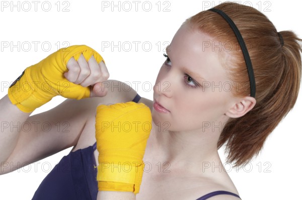 A beautiful young woman wearing a pair of boxing gloves