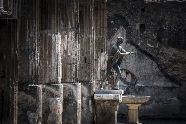 POMPEII, ITALY, MAY 04, 2022, Colonnade and sculptures of the Temple of Apollo near the Pompeian forum, Southern Italy