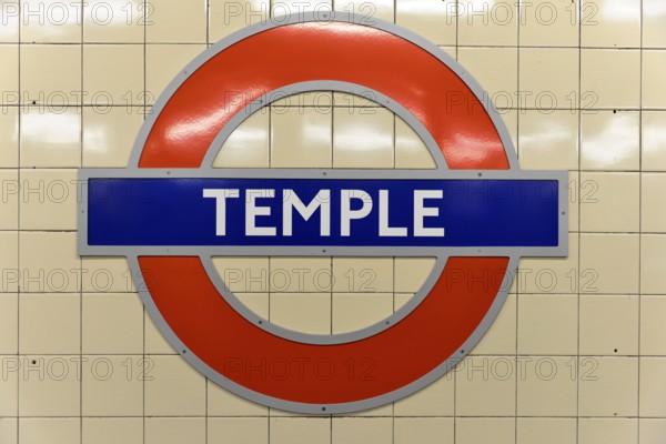 The red and blue Tube logo of Temple Station on a tiled background, London, London region, England, United Kingdom, Europe