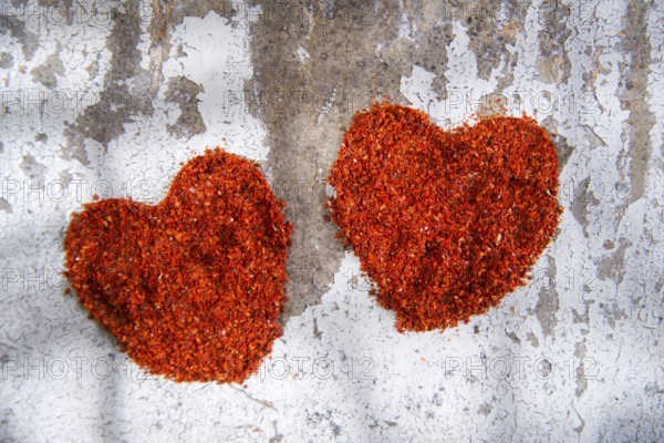 Presentation of two hearts made of chili powder