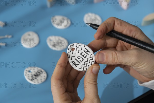 Master class writing word RISEN on EASTER clay egg Children air dry clay activity handicraft idea. DIY process step by step instruction. Preparing for Easter holiday decorating. Modern organic design minimalistic plastic free sustainable decor