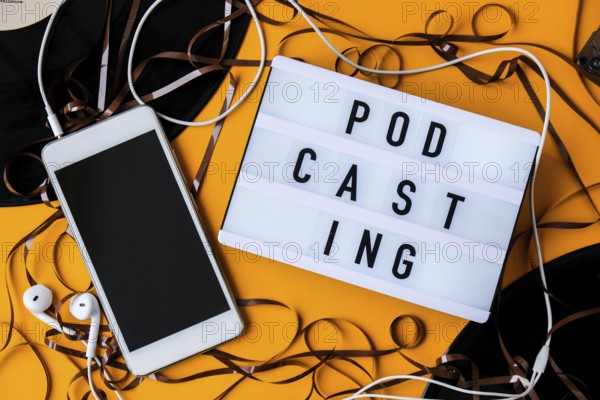 Podcasting lettering and vinyl record audio cassette tape album headphones and mobile phone. Millenial. Blogger, podcaster. Retro style. Audiobooks. New episode available