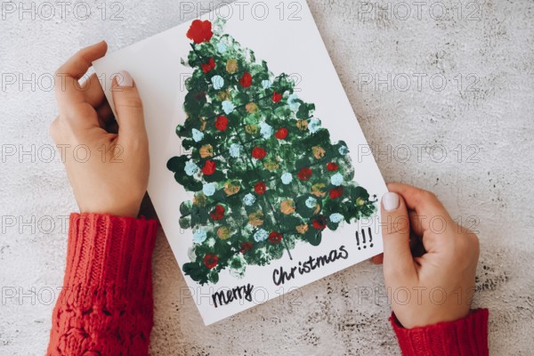DIY Making greeting card Handmade crafts on holiday for children. Step by step. Do it yourself. Happy New Year xmas tree decoration Paint with fingers Merry Christmas tree. Top view