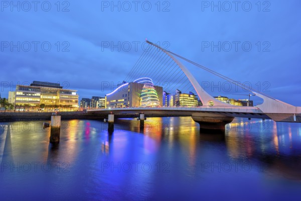 The River Liffey with the Samuel Beckett Bridge in Dublin, Ireland, at dusk, Europe